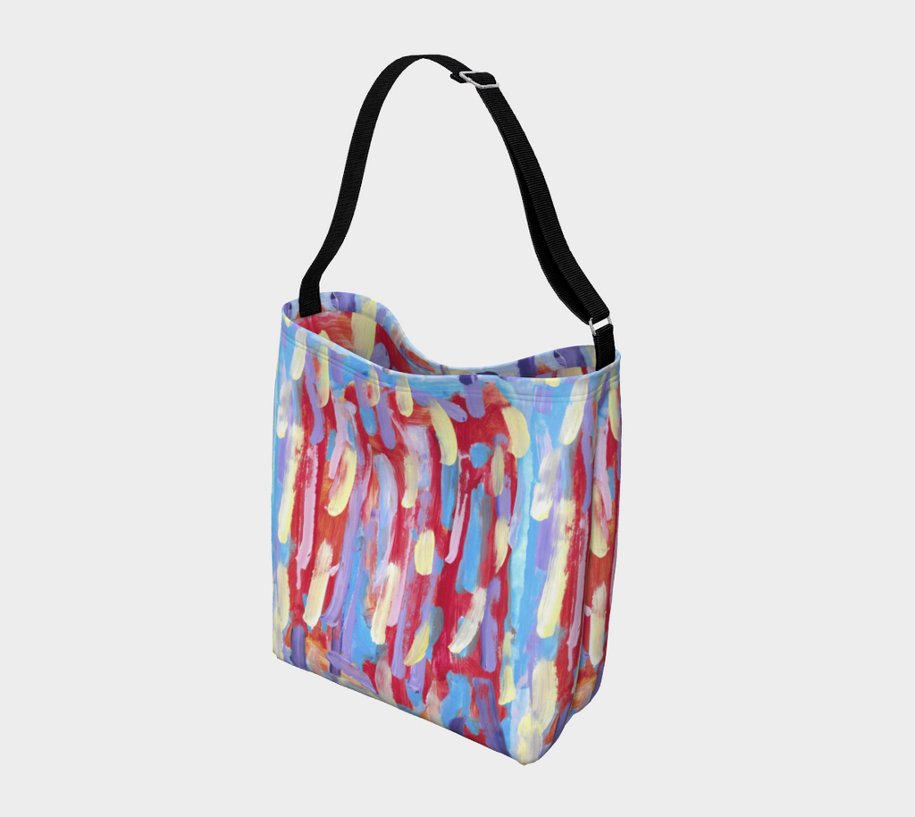 Crossbody Bag, with black strap, Against an orangish-red blackground are pale streaks of pink, yellow, lavender, and sky blue. 