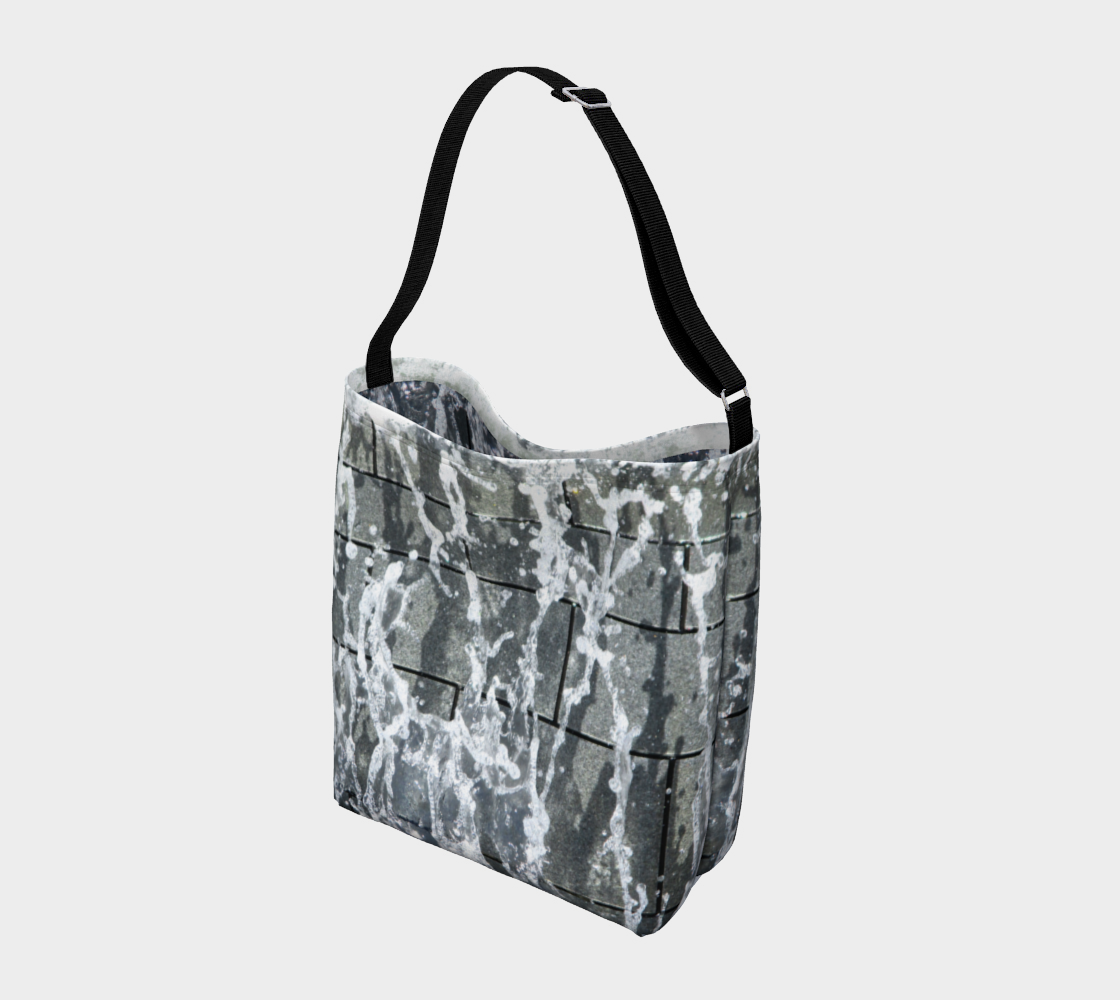 Crossbody tote with black strap with gray, white and black design depicting running water