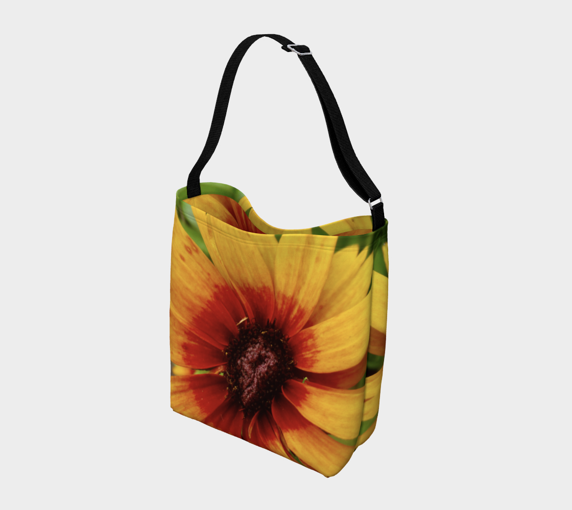 This is a crossbody bag with a photo of a yellow flower with a red center