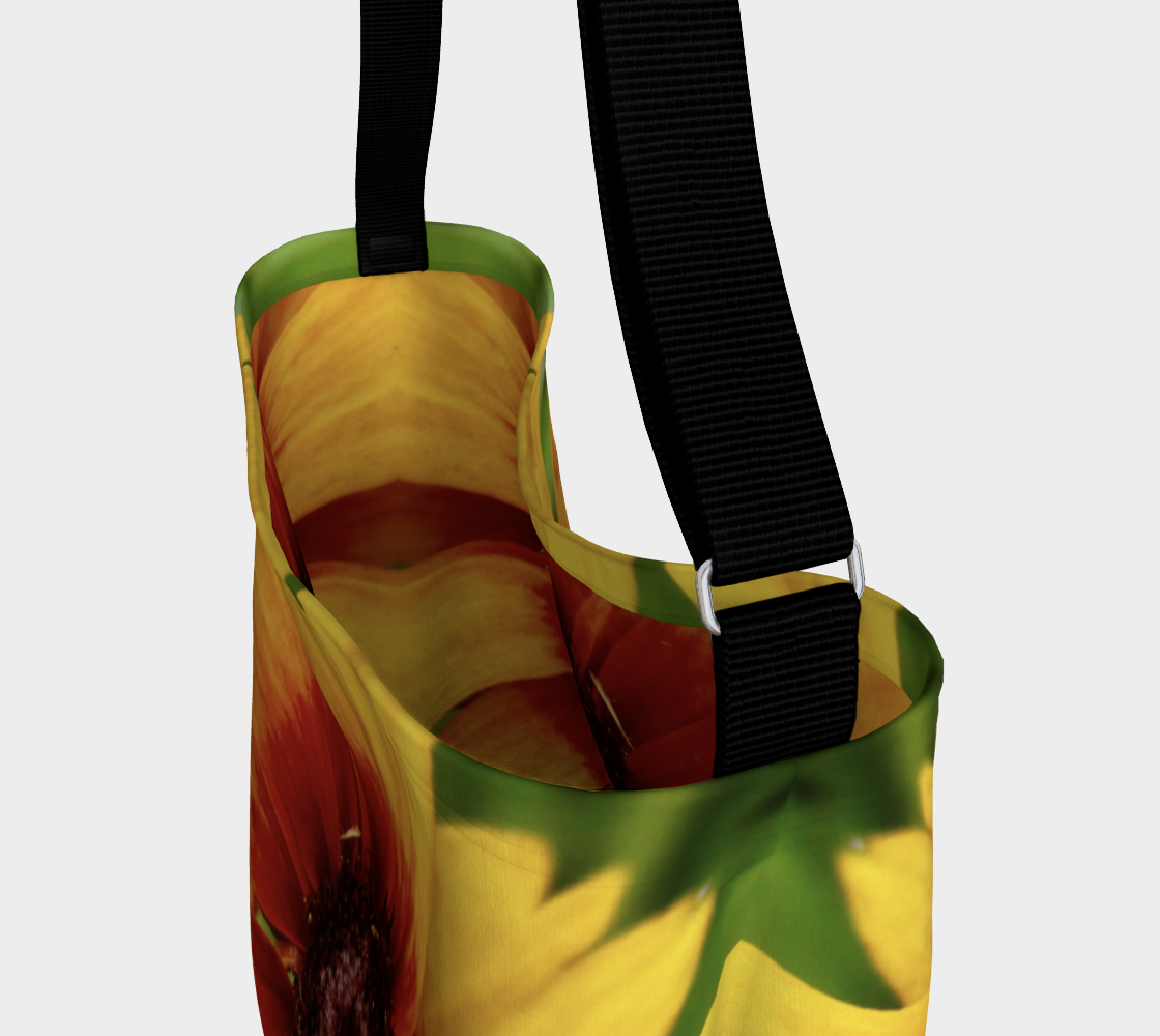 This is the top of a crossbody bag with a photo of a yellow flower with a red center