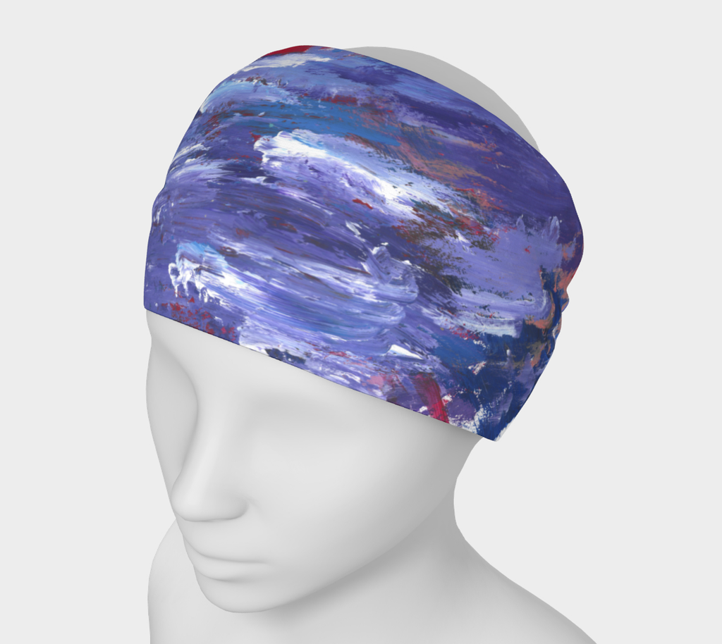 A thick head band with pattern of abstract painting with short horizontal brushstrokes of all shades of purple. In the background seeping through gaps and edges of the purple strokes are sections of blue, red, and coral color.
