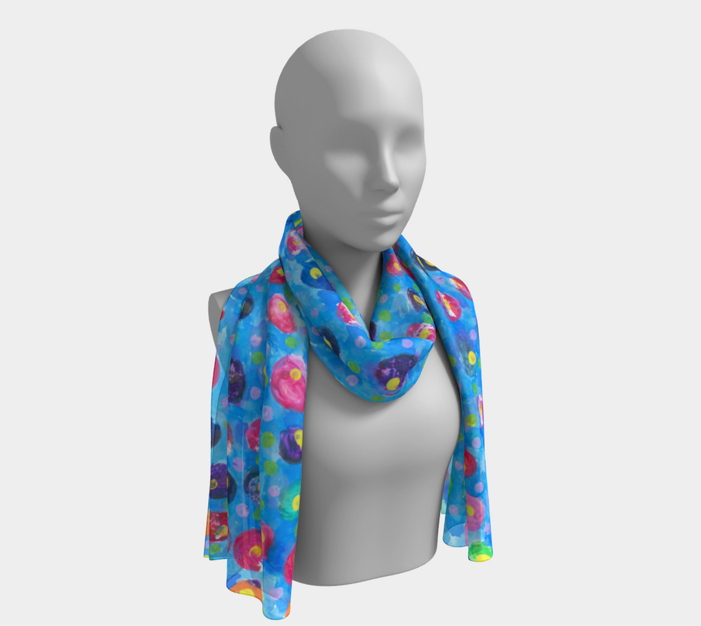 This is a scarf with a blue background and multicolored dots with yellow centers. The colors include: purple, pink, orange, and blue.