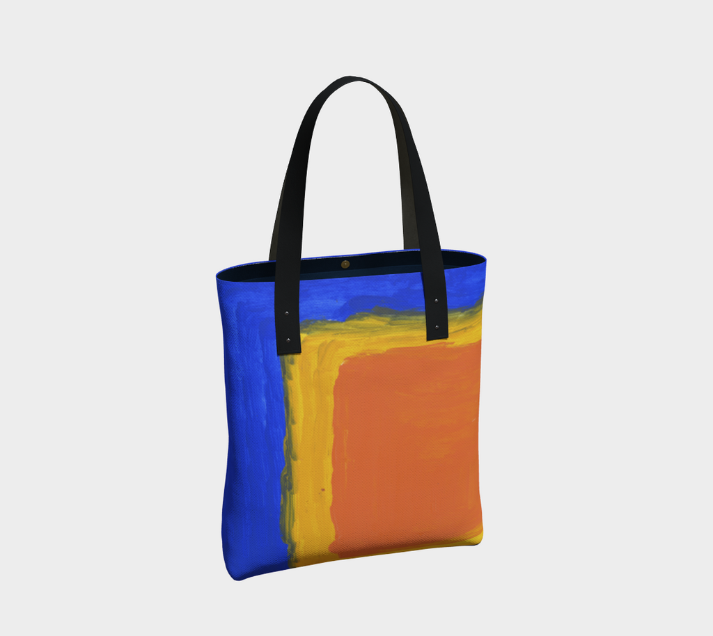 Lined tote bag with magnet clasp and vegan leather black straps. The pattern is a blue background and large yellow and orange square in lower right hand corner