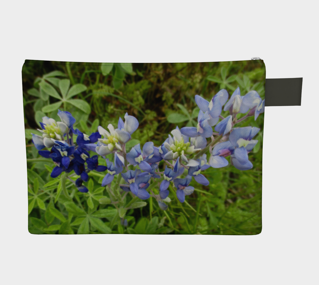 Back view of CarryAll Bag with purple and blue flowers and greenery photograph design. Black wrist strap and zipper closure.
