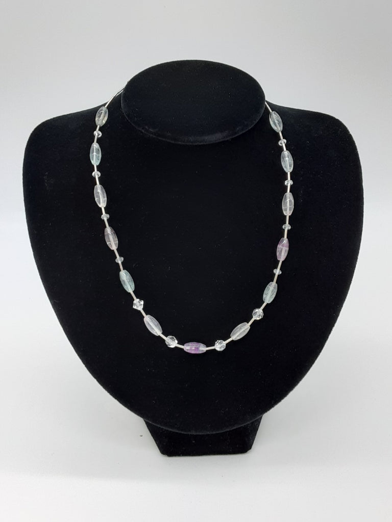necklace os alternating metal cylinder beads with clear and slightly tinted oval beads in between 