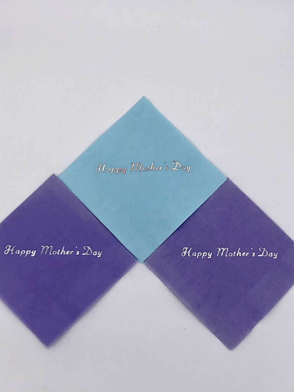Purple and light blue cocktail napkins with silver Happy Mother's Day slogan