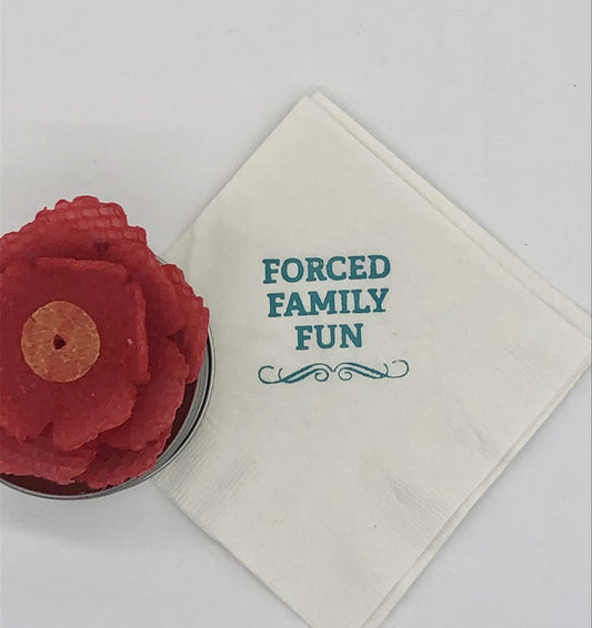White cocktail napkins with teal Forced Family Fun slogan