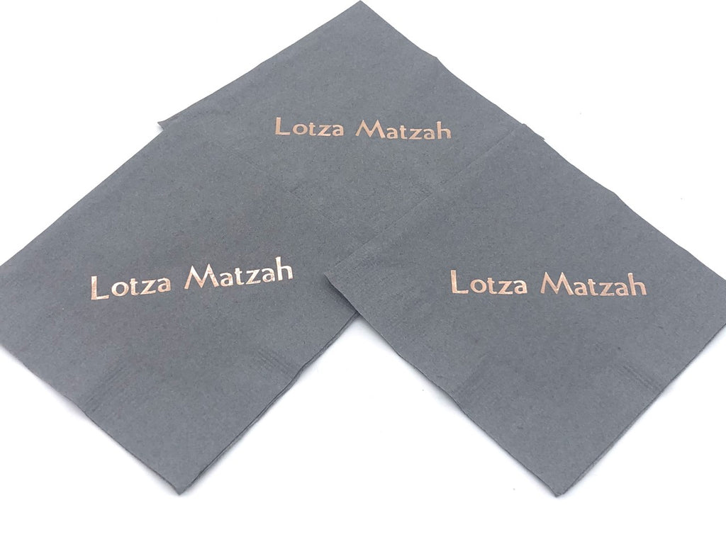 Black coctail napkins with copper Lotza Matzah slogan