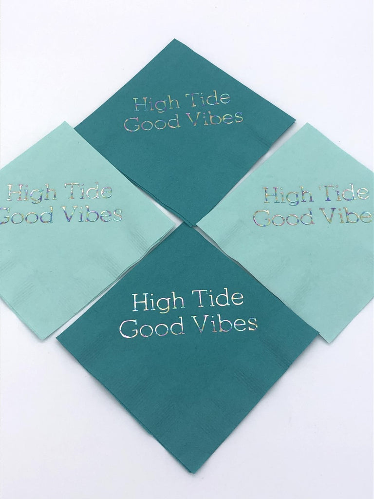 Teal and seafoam cocktail napkins with iridescent High Tide Good Vibes slogan