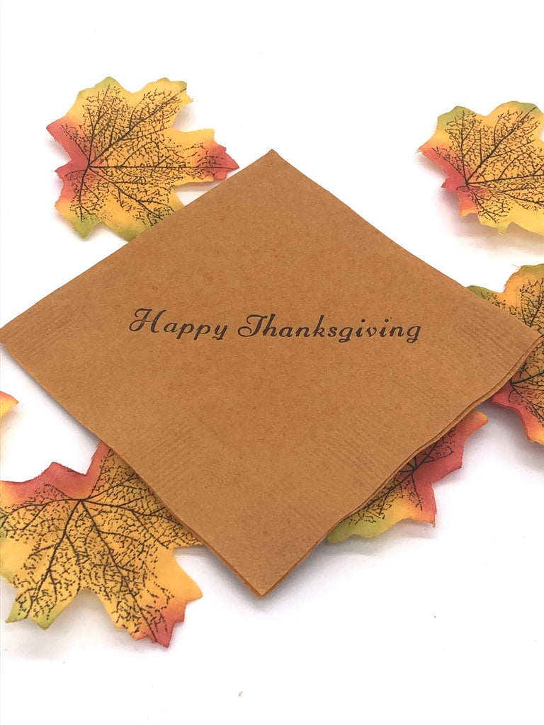 Light brown cocktail napkins with dark brown Happy Thanksgiving slogan