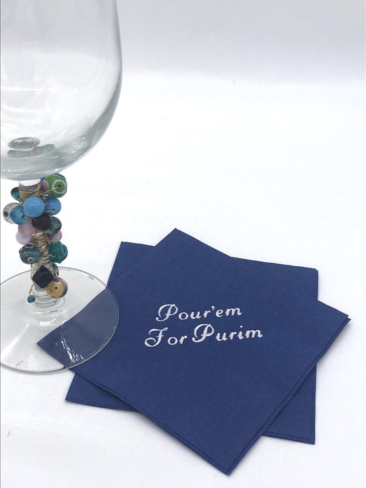 Blue cocktail napkin with silver Pour'em for Purim slogan