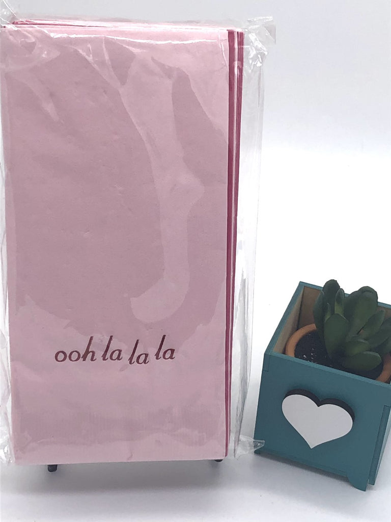 Light pink dinner napkins with ohh la la la slogan at the bottom