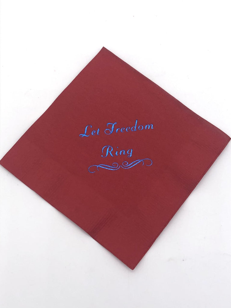 Red cocktail napkin with blue Let Freedom Ring slogan