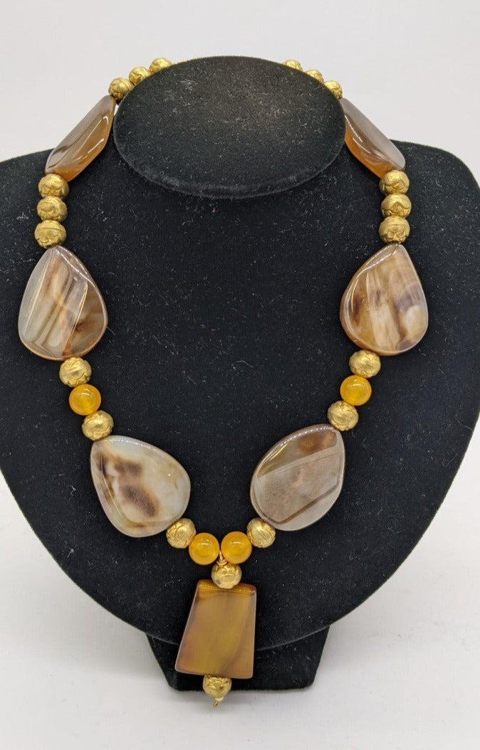 necklace with large brown stone beads with gold and orange round beads in between