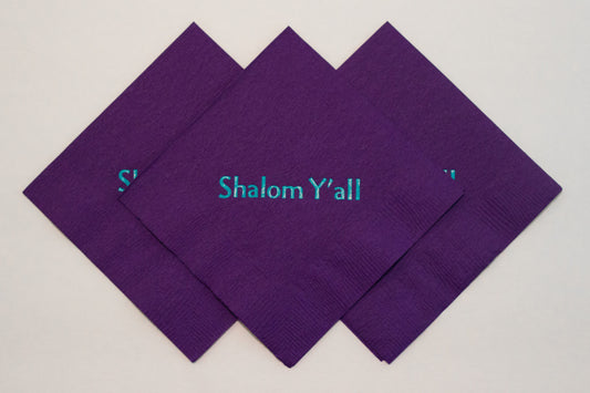 Purple cocktail napkins with turquoise Shalom Y'all slogan